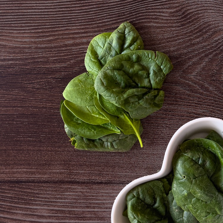Product photography featuring fresh spinach, one of the ingredients in Virchew dog food